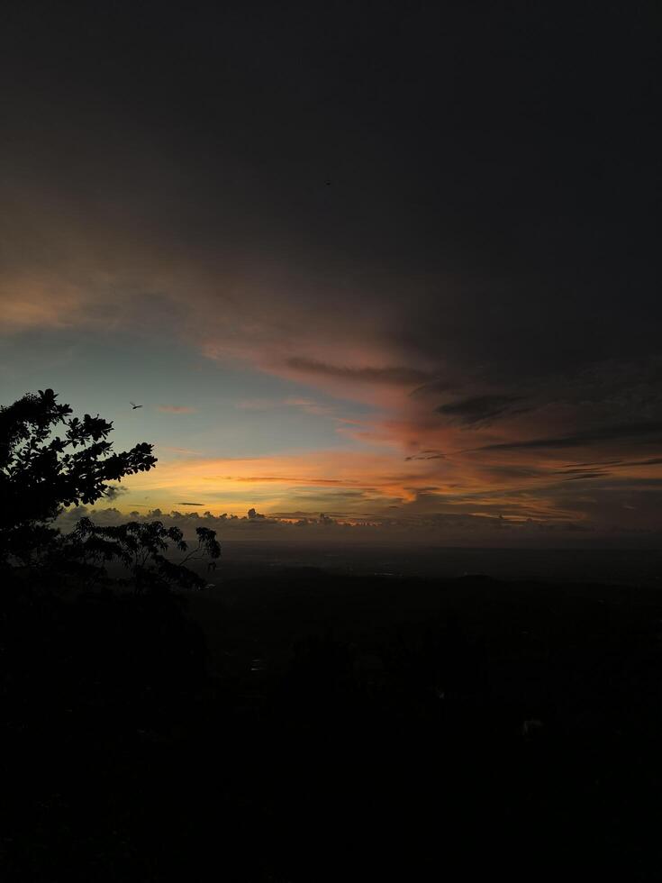 sunset seen from the top of the hill at dusk photo