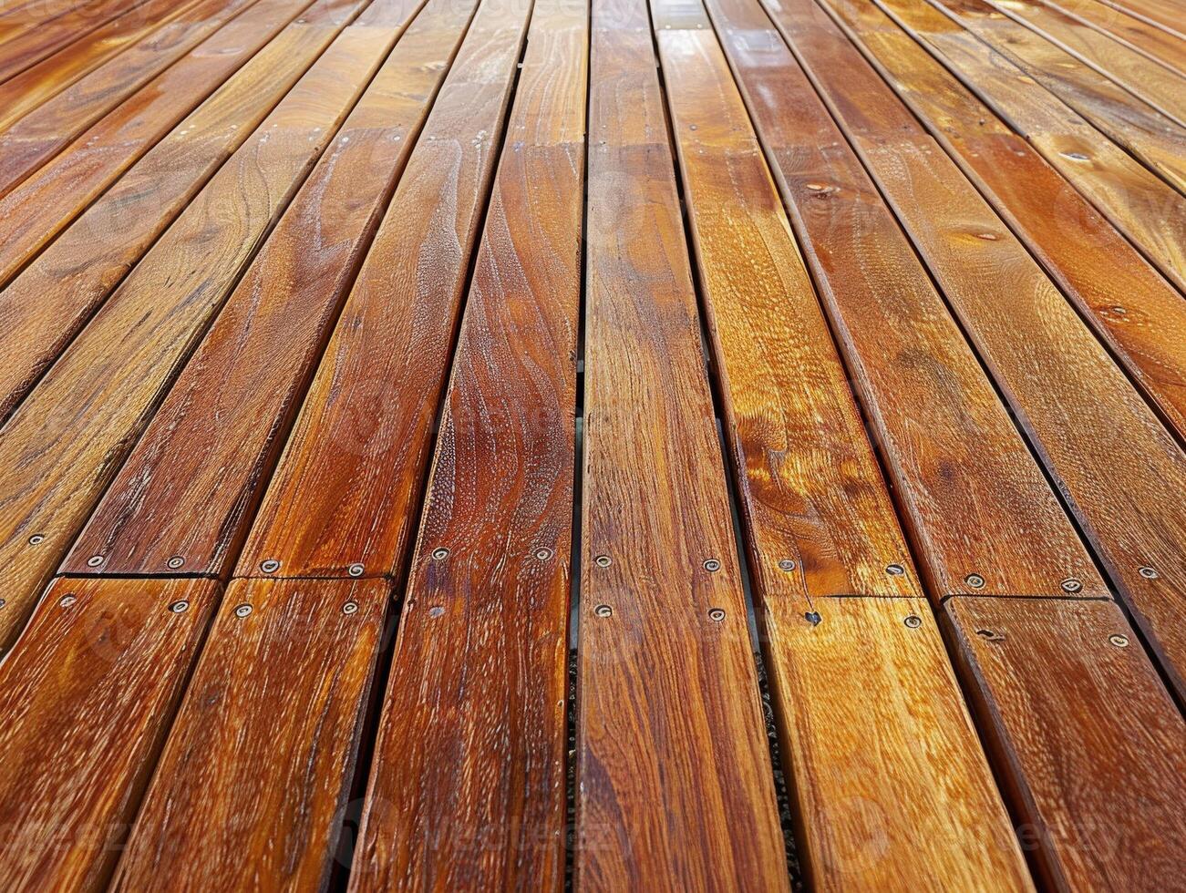 Wooden decking planks in warm tones on a sunny day photo