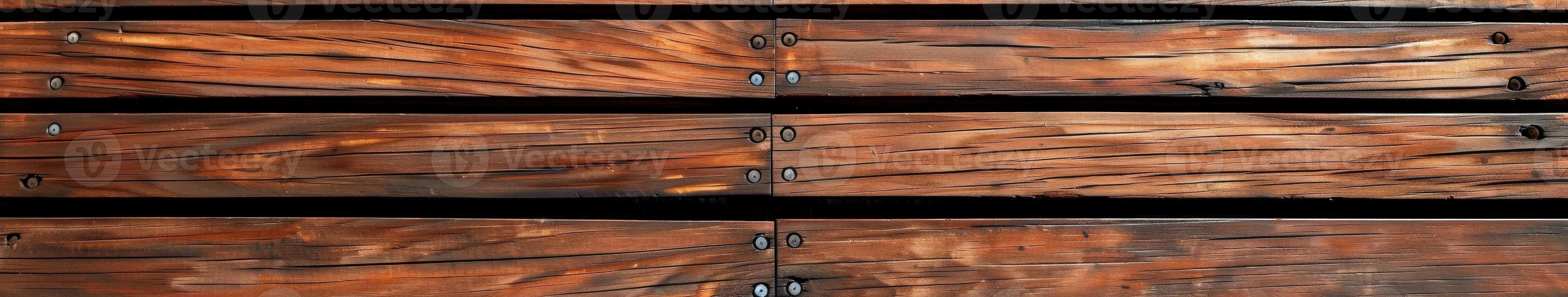 Wooden decking boards with screws in a close-up view during daylight photo