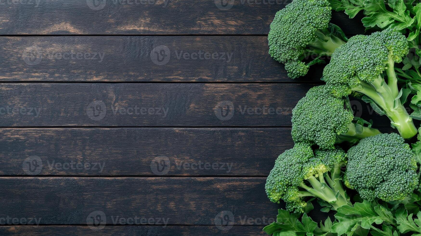 Fresh broccoli arranged on a wooden surface in natural light photo