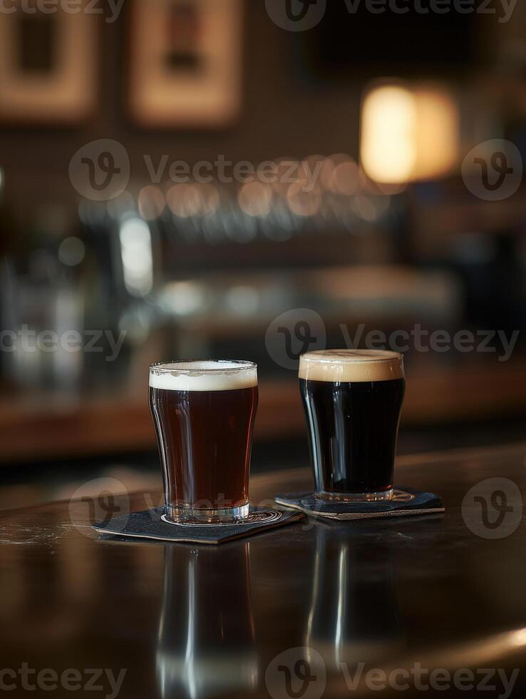 Two glasses of dark and light beer on a bar counter at night photo