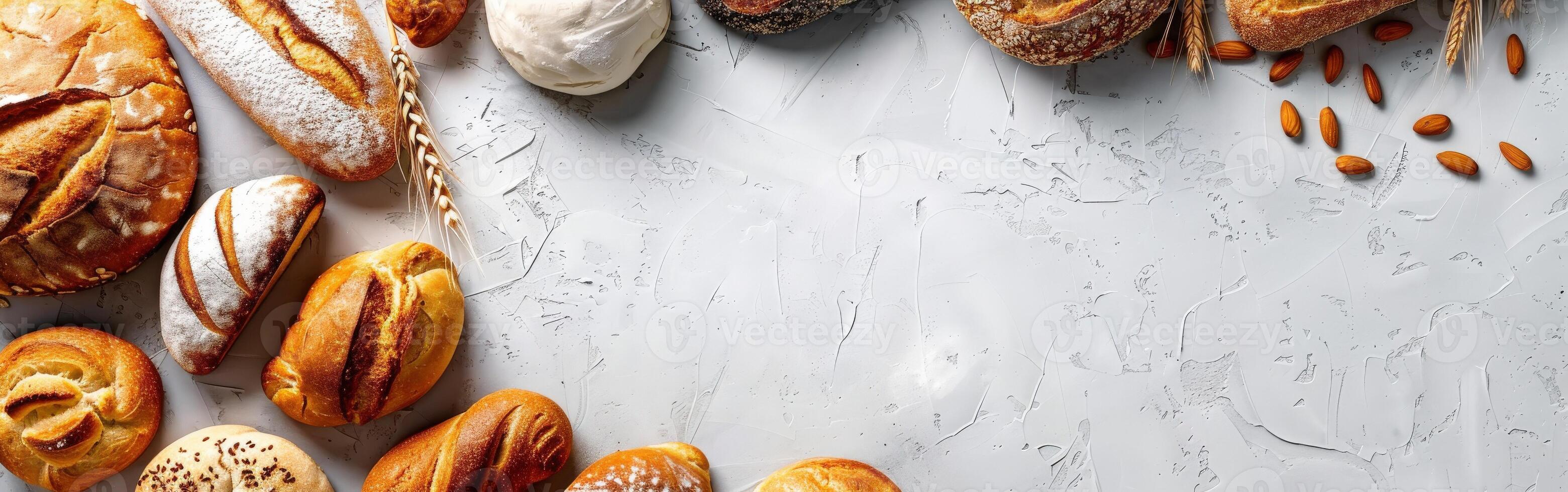 Freshly baked artisan bread arranged on a textured surface with space photo