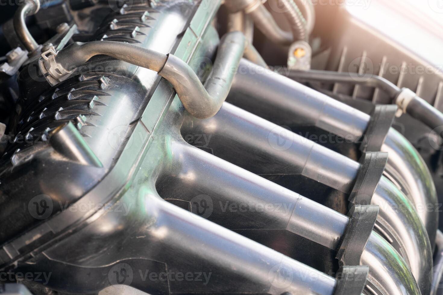 Close up of the engine of a modern car four cylinder with a blurred background. Open protection of front engine. Open the front cover to reveal the curved piston rod. photo
