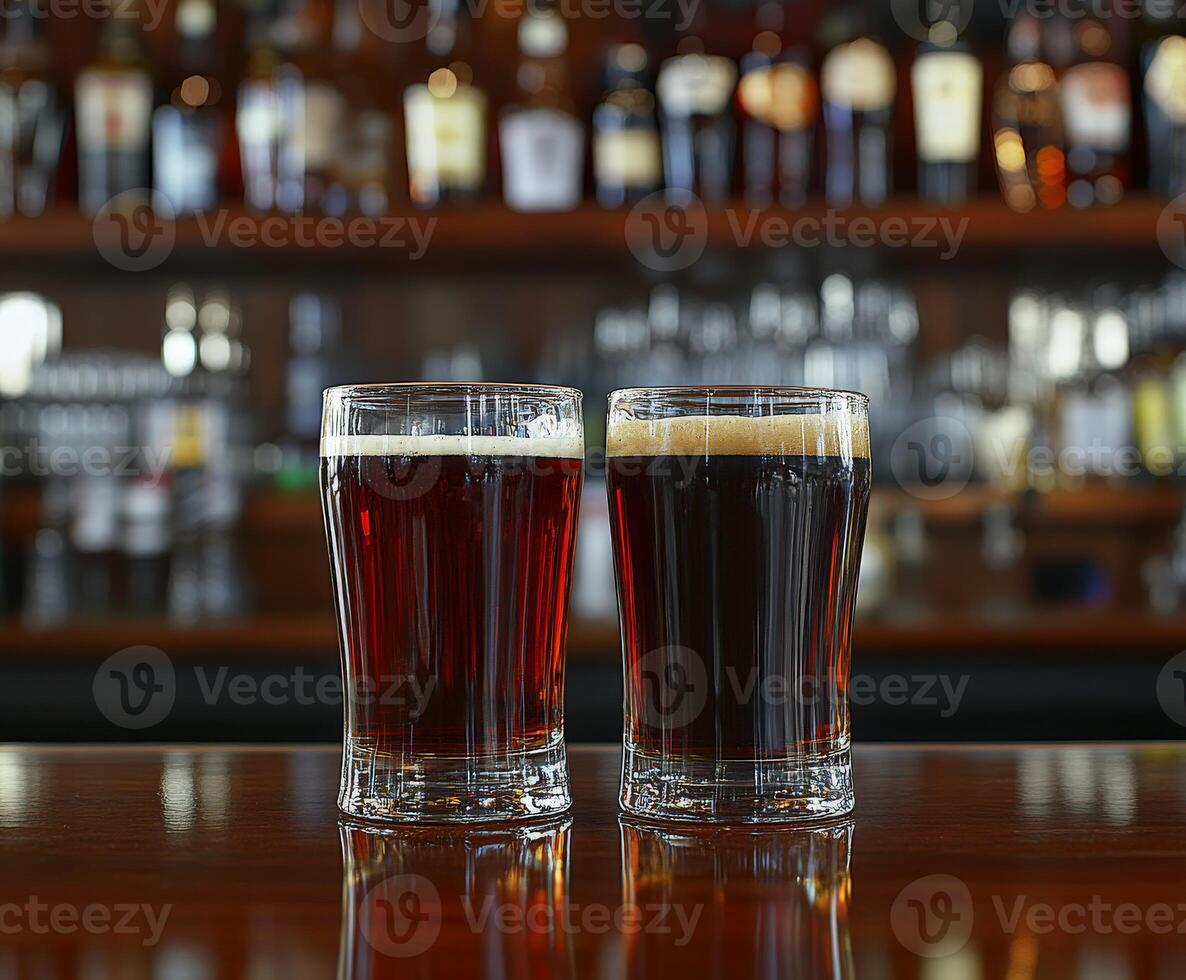 Two glasses of dark and light beer on a bar counter photo