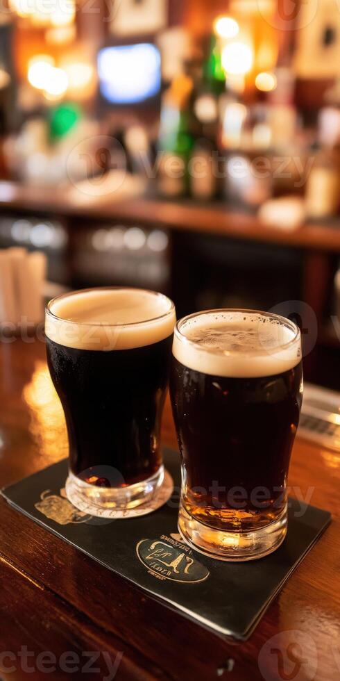 Two glasses of dark and light beer on a bar counter in a pub photo