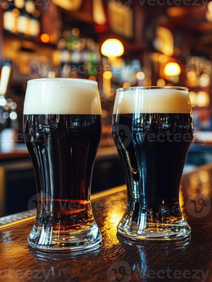 Two glasses of dark and light beer on a wooden bar counter photo