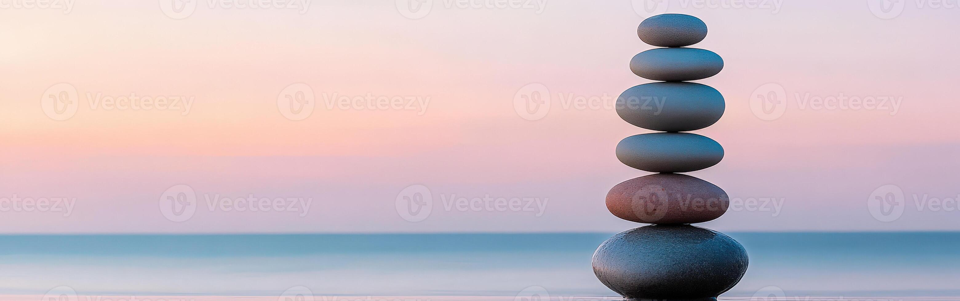 Balanced zen stones at sunrise by the calm sea photo