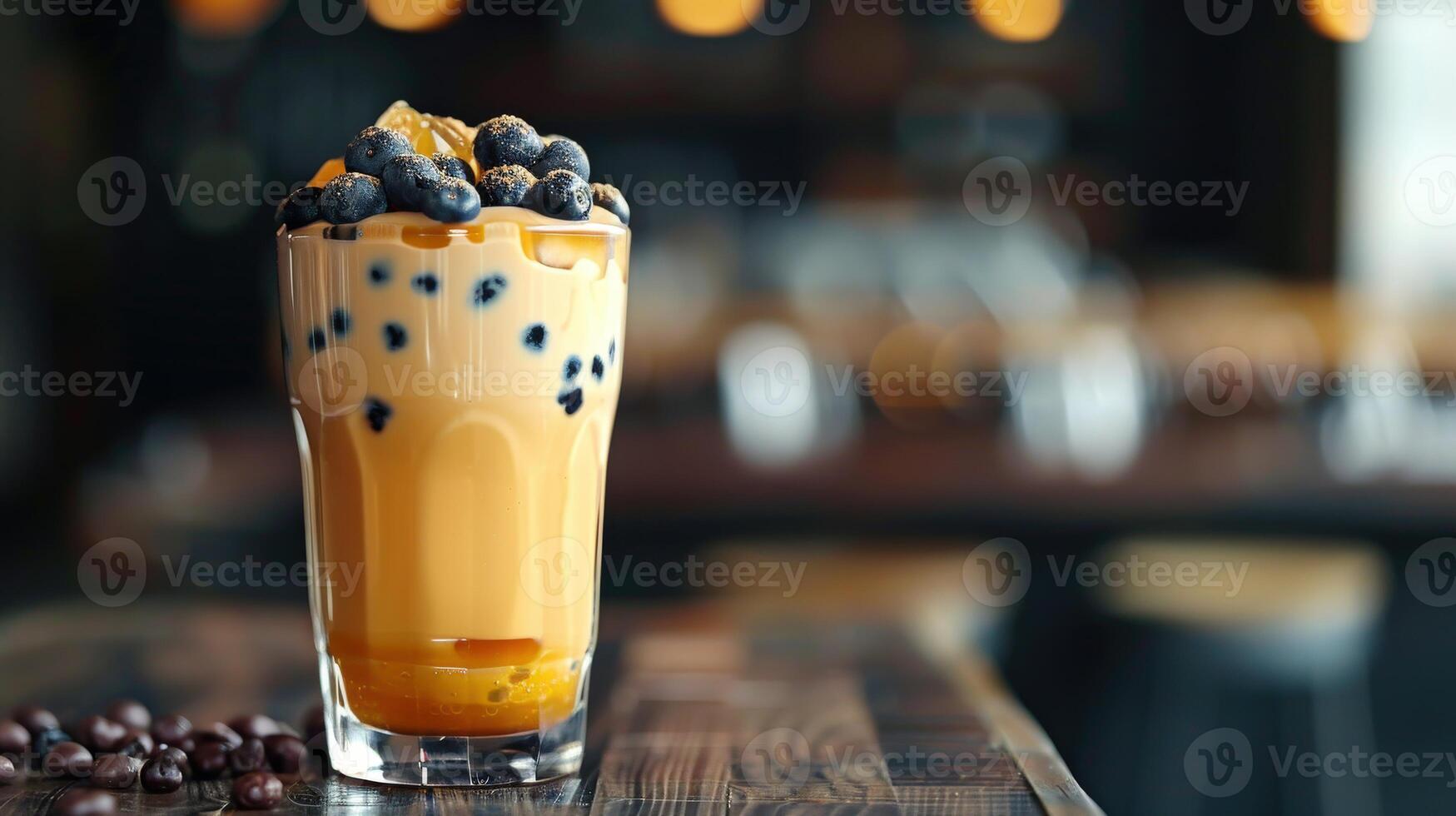 Boba milk tea topped with fresh blueberries in a cozy cafe setting photo