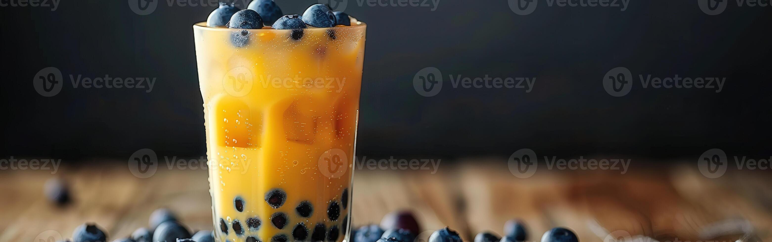 Boba milk tea topped with fresh blueberries on a wooden table photo