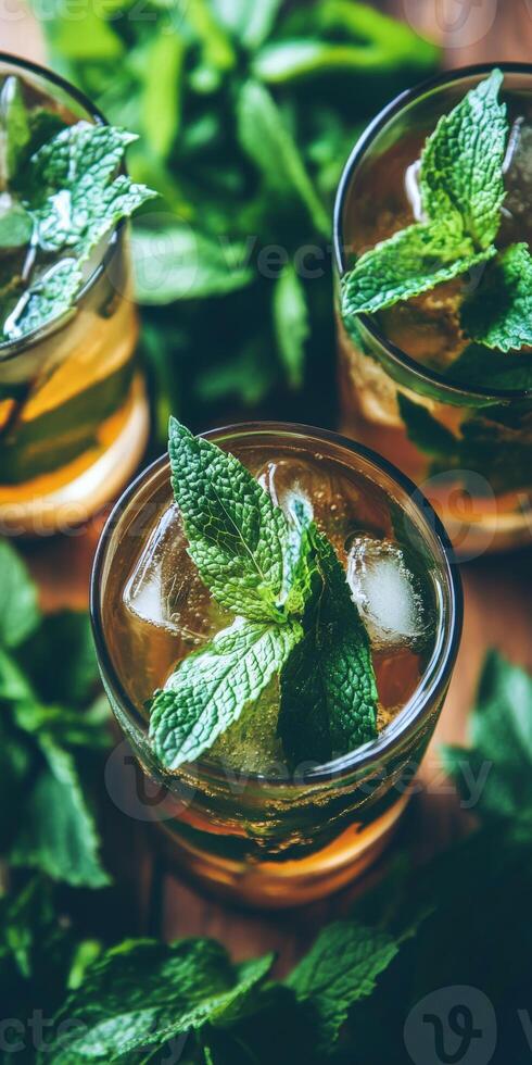 Refreshing green mint lemonade with ice cubes in summer sun photo