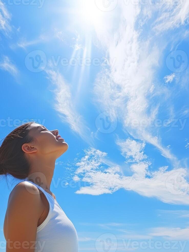 High school girl looking up at a clear blue sky during the day photo