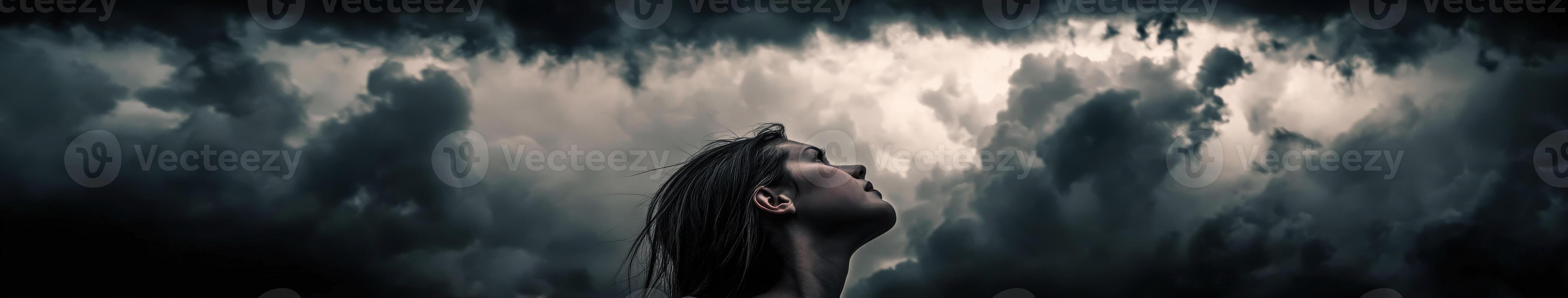 High school girl gazing up at a cloud-covered sky during twilight photo