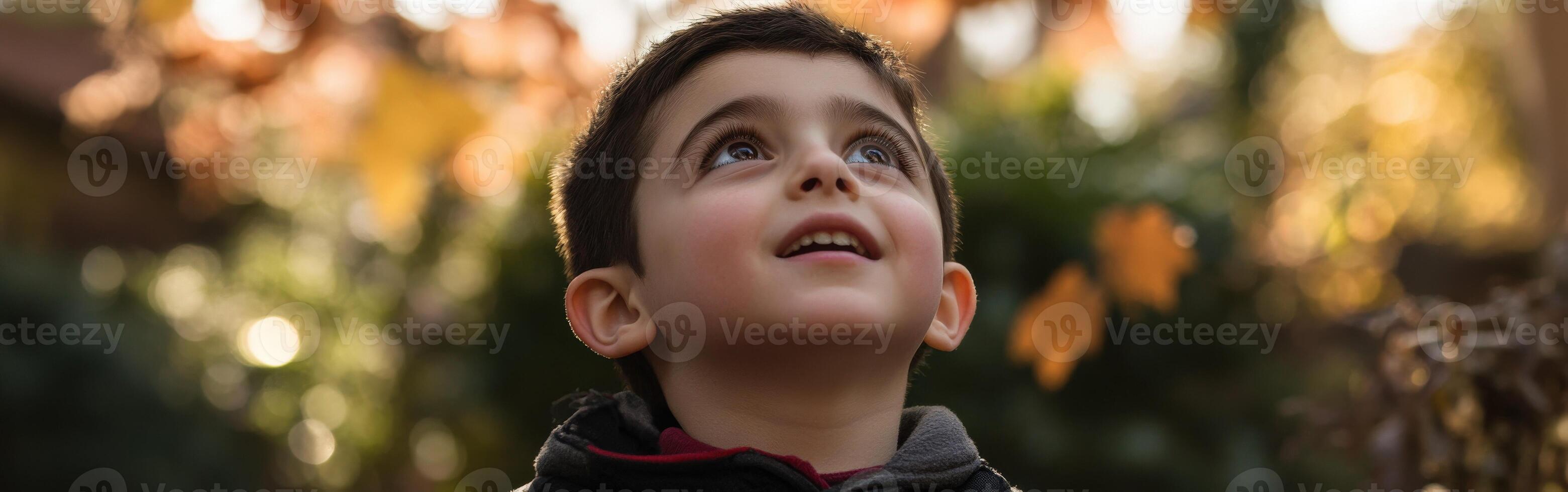 High school boy gazing up at the sky during a sunny afternoon outside photo