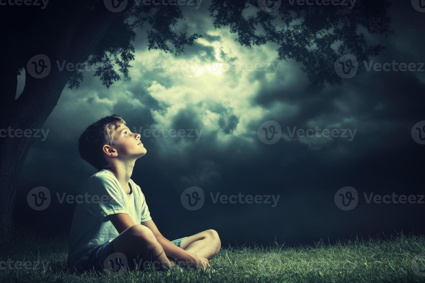 High school boy gazing up at cloudy skies during twilight outdoors photo