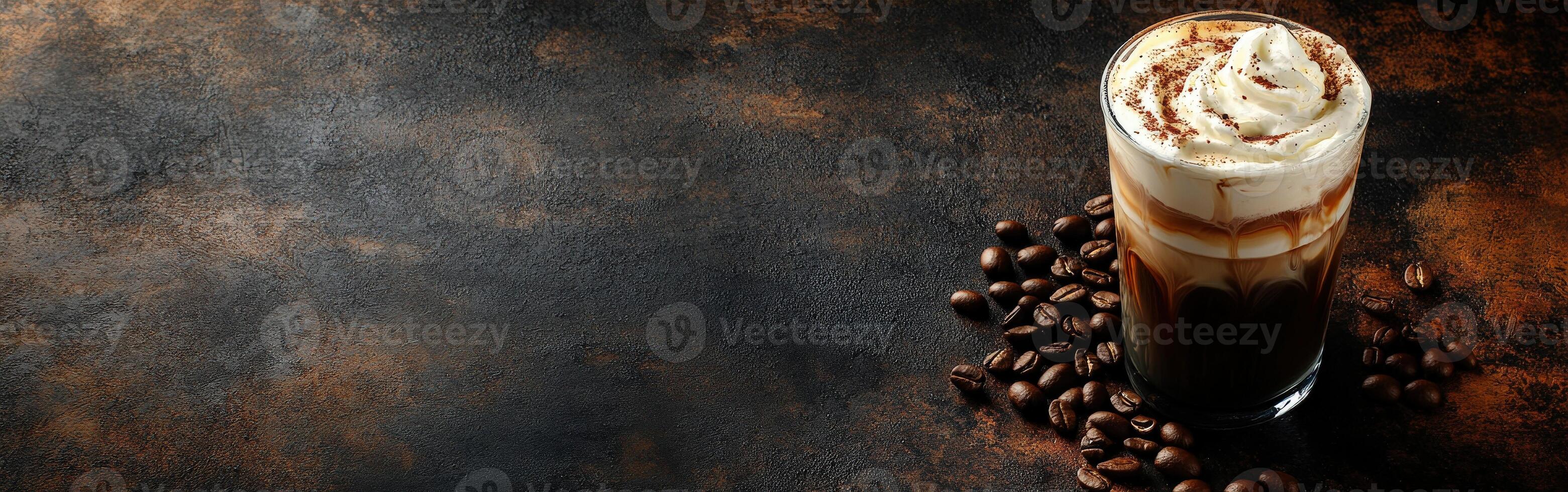 Iced coffee with cream and coffee beans on a dark surface photo