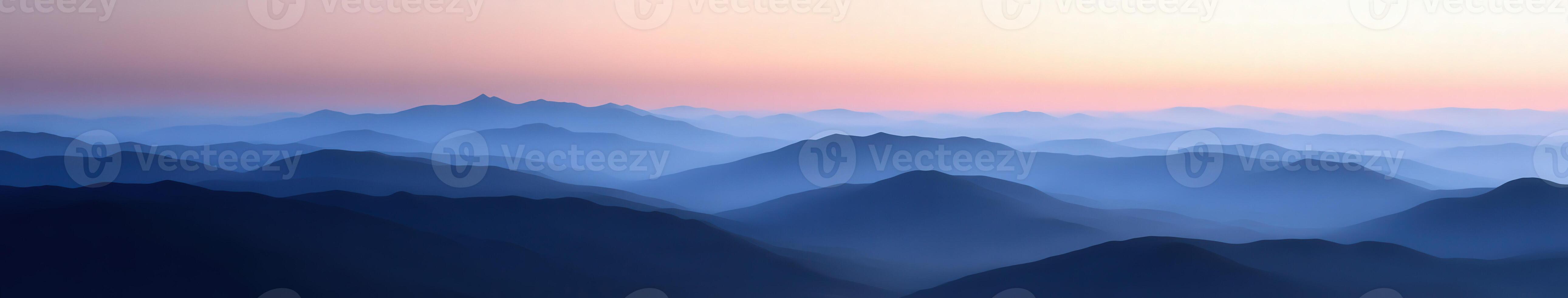 Mountains shrouded in evening fog with soft pastel sky at dusk photo