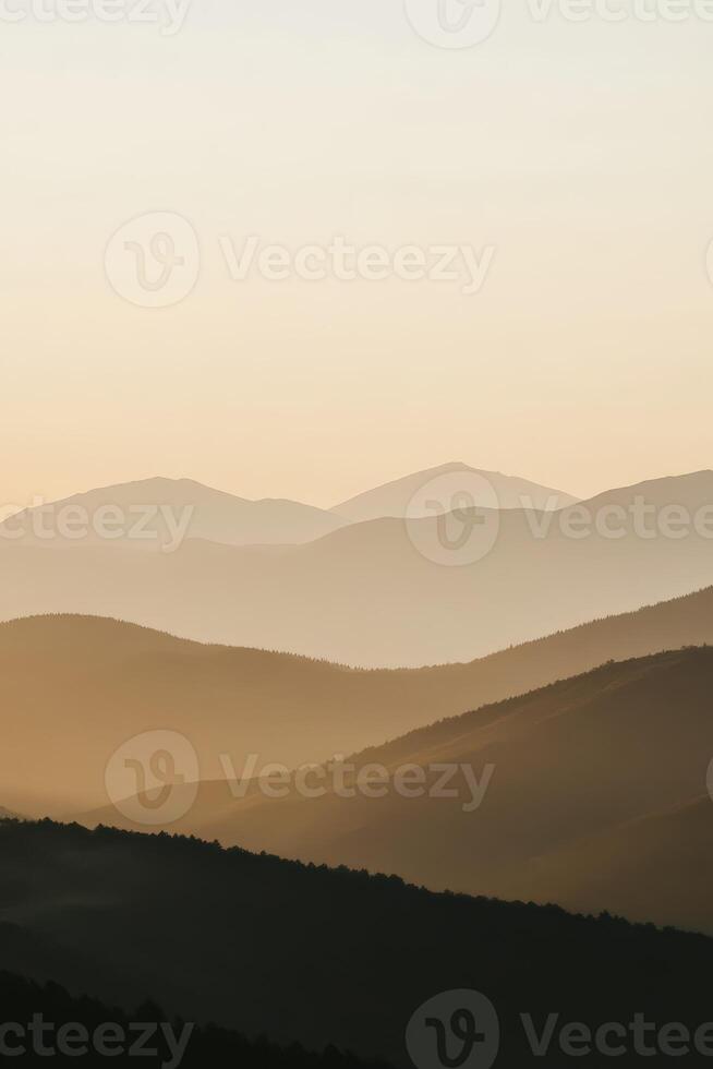 Evening fog envelops mountains in a tranquil landscape photo
