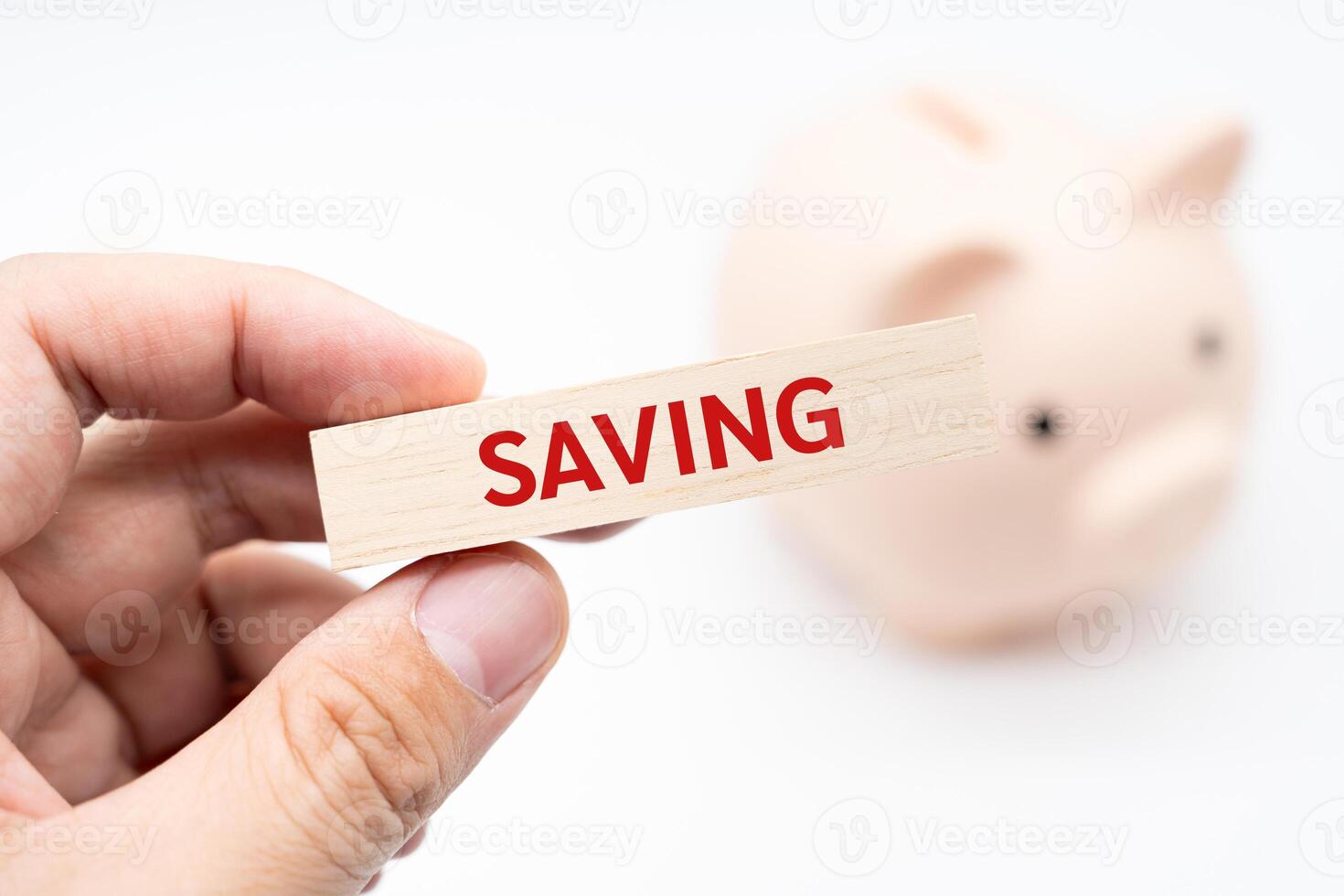 Text SAVING on wooden block with piggy bank on the background. Financial and business concept. retirement saving concept. Concept of money saving for rainy day. photo