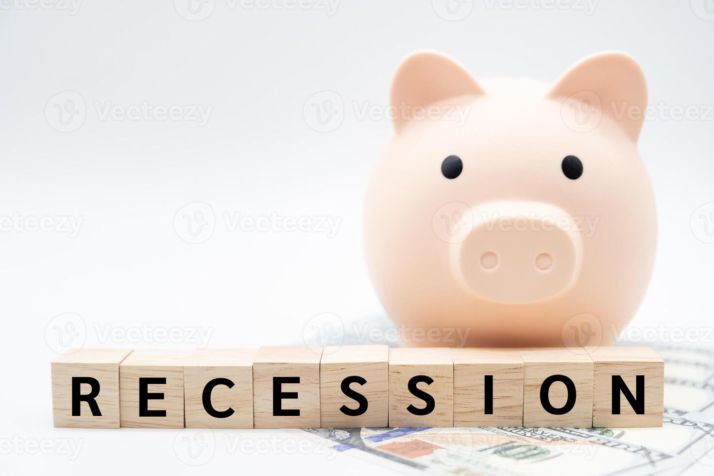 Wooden blocks with RECESSION wording and Piggy bank. Business and education concept. Copy space. Global economic crisis. Recession business and stock crisis concept. photo