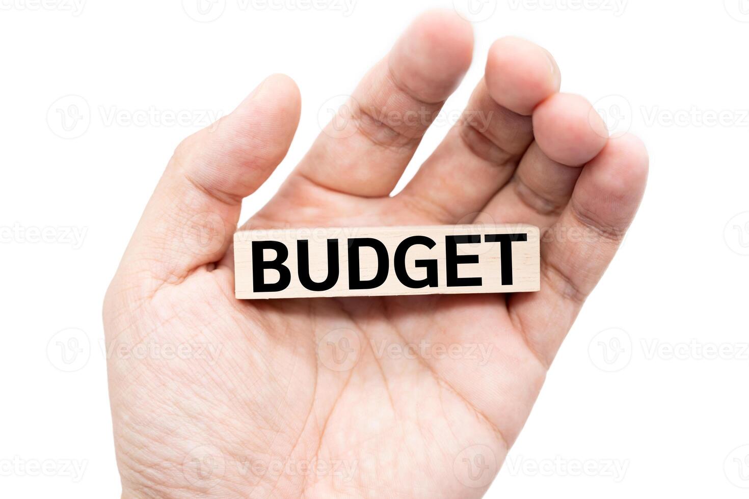 Text BUDGET wooden block on hand with Clipping path isolate on white background. Financial and business concept. Budget planning concept. photo