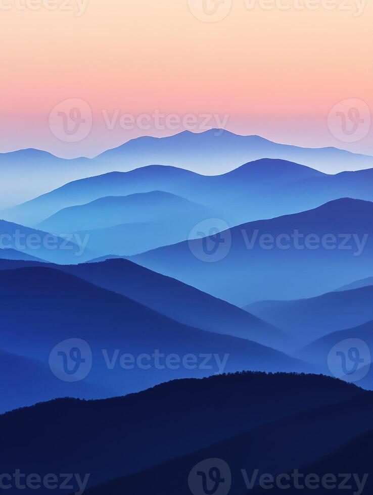Evening fog envelops mountains creating a serene twilight landscape photo