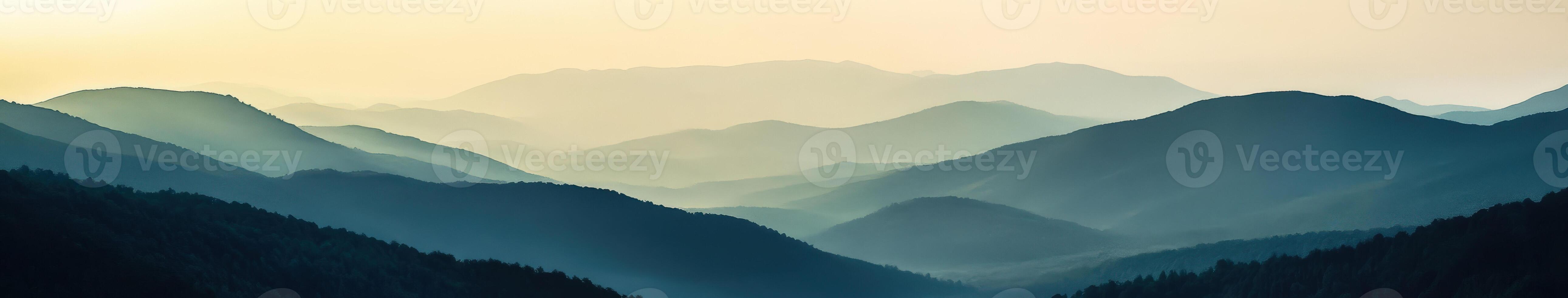 Foggy mountain landscape at dusk with layered hills in the distance photo