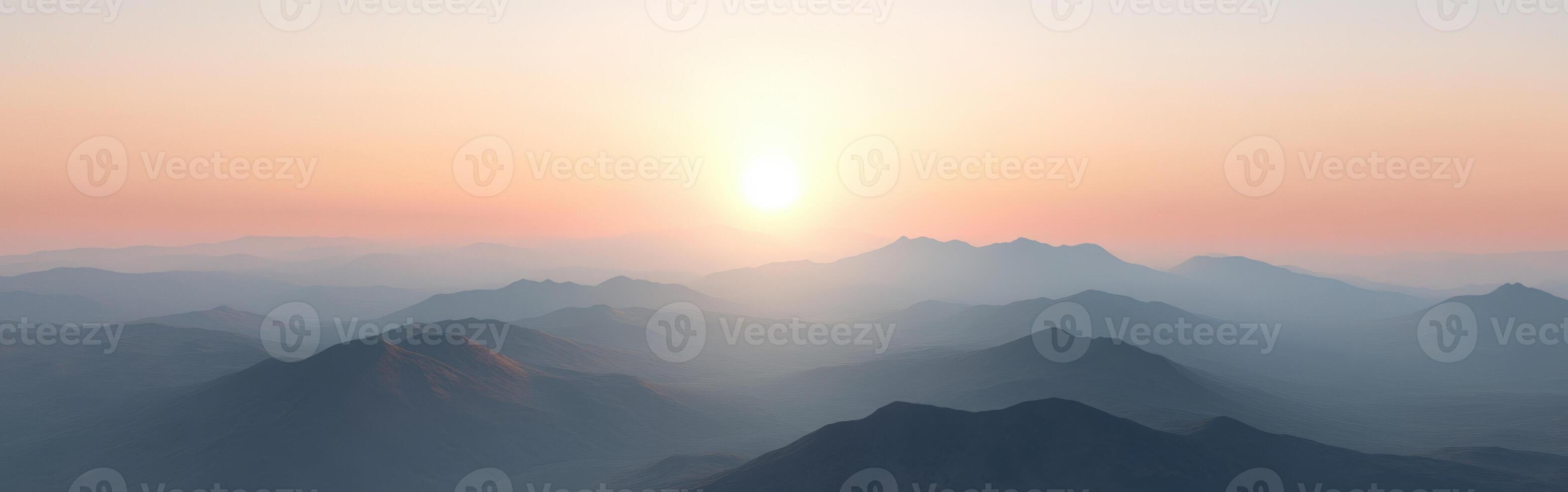 Evening fog blankets mountains as the sun sets behind peaks photo