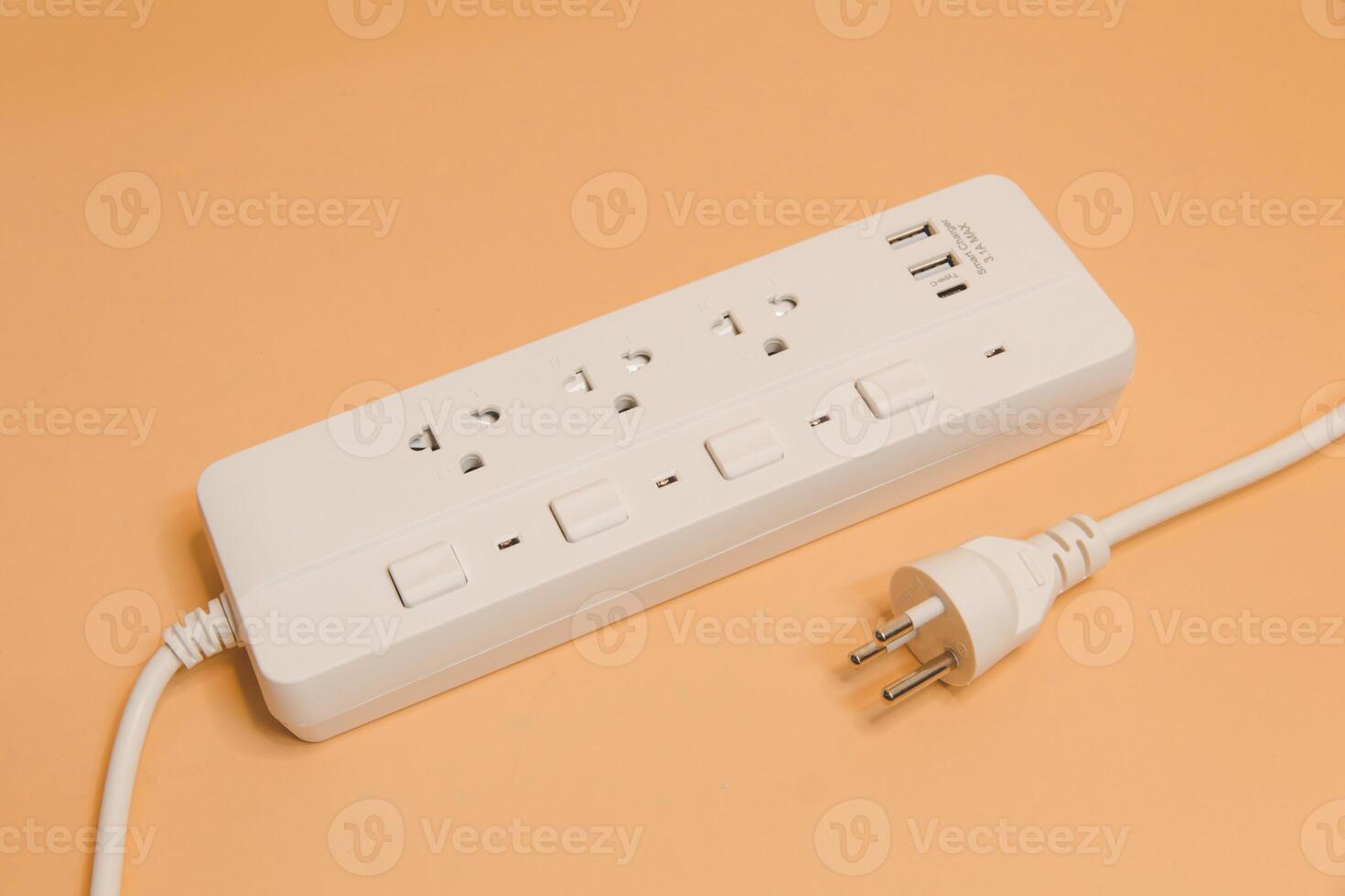 Electrical plug in outlet socket at home, Electrical plug in outlet socket at home, Energy efficiency concept, Power strip with extension cord on beige background, top view. photo