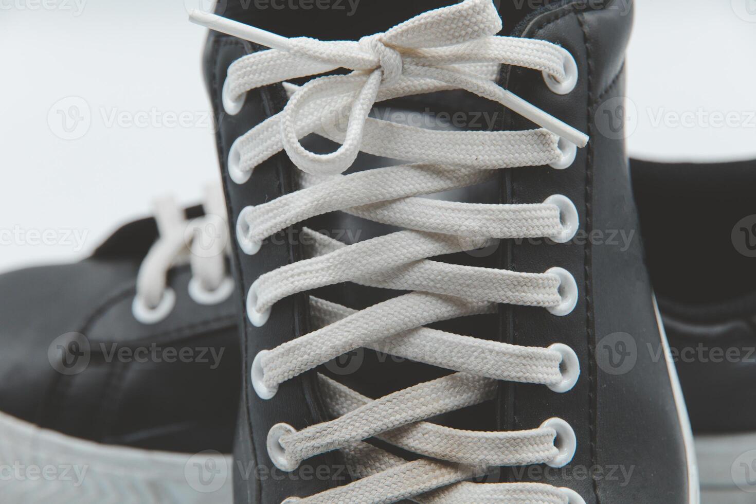 shoe sneaker on white background, close up of sneaker on white background, old black generic sneakers on white background. photo