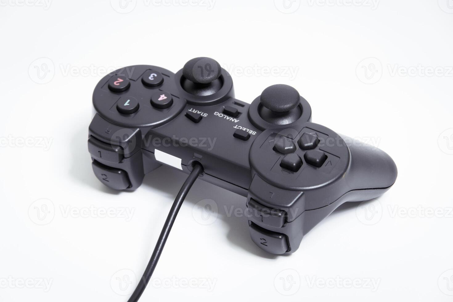 Black controller on white background, game device, Joystick on a white background. photo