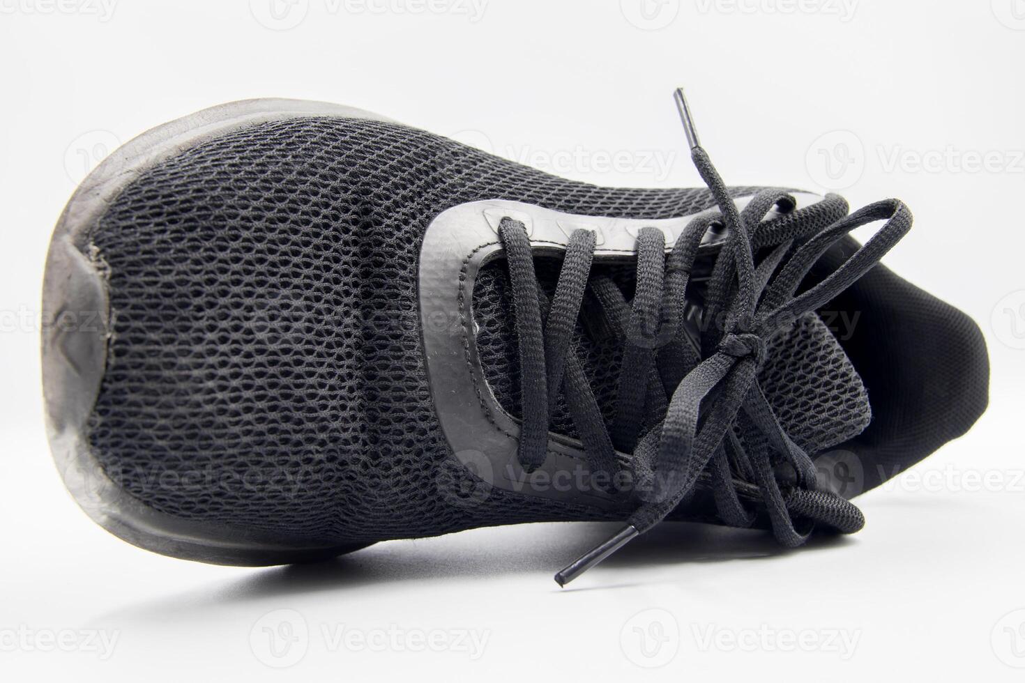 shoe sneaker on white background, close up of sneaker on white background, old black generic sneakers on white background. photo
