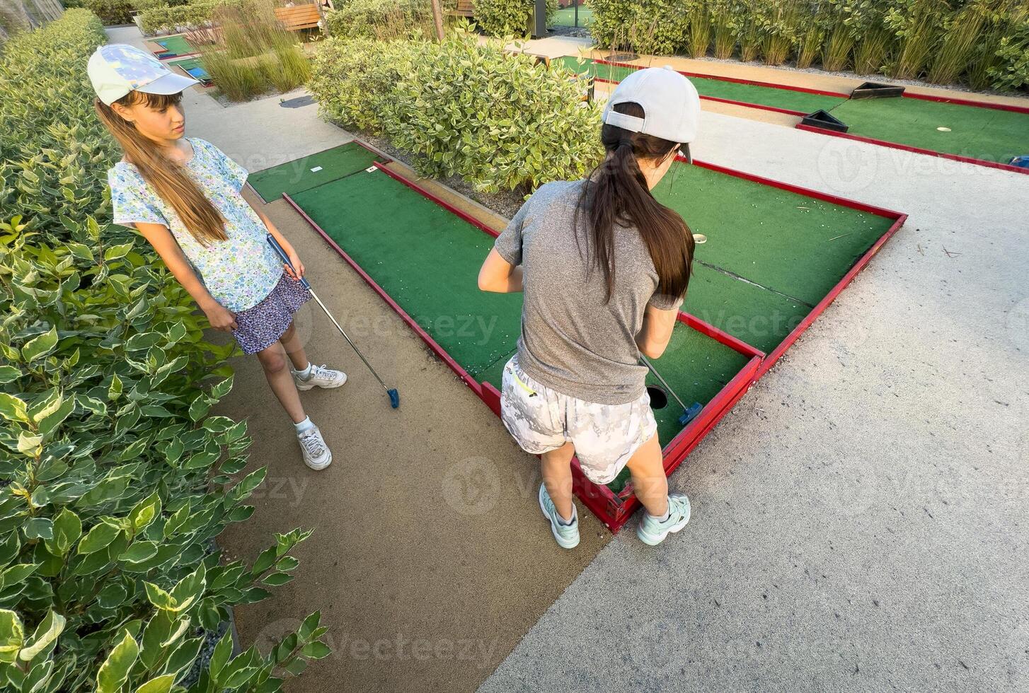 Children playing mini golf. Child golfer photo