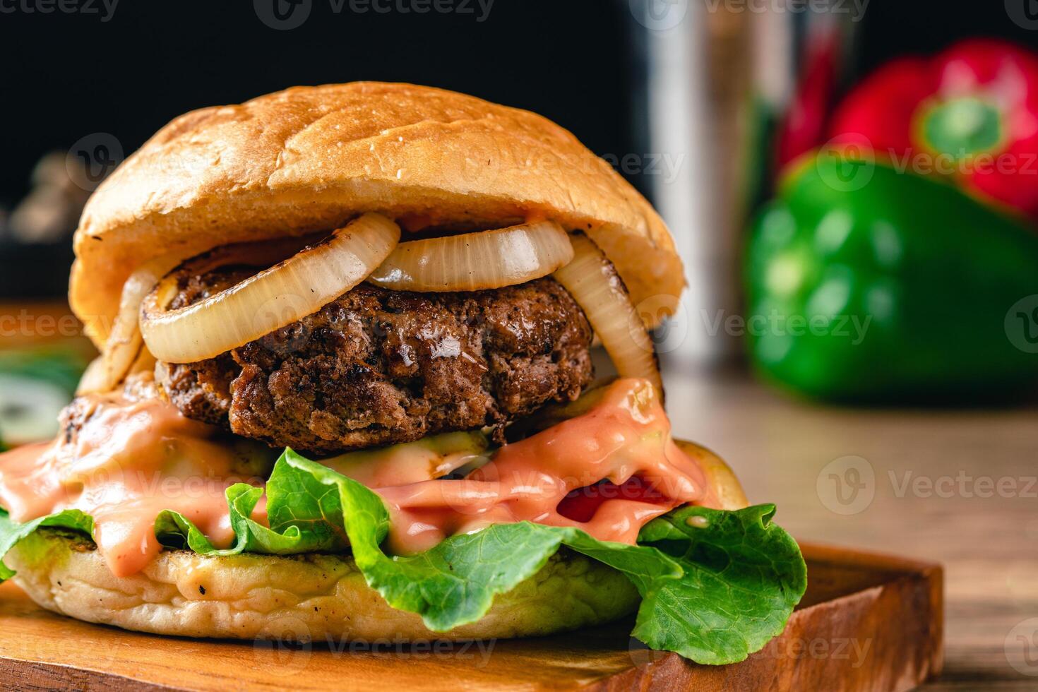 Fresh grilled homemade burgers with beef, tomato, fried egg, cheese and lettuce on rustic wooden background. fast food and junk food concept. photo