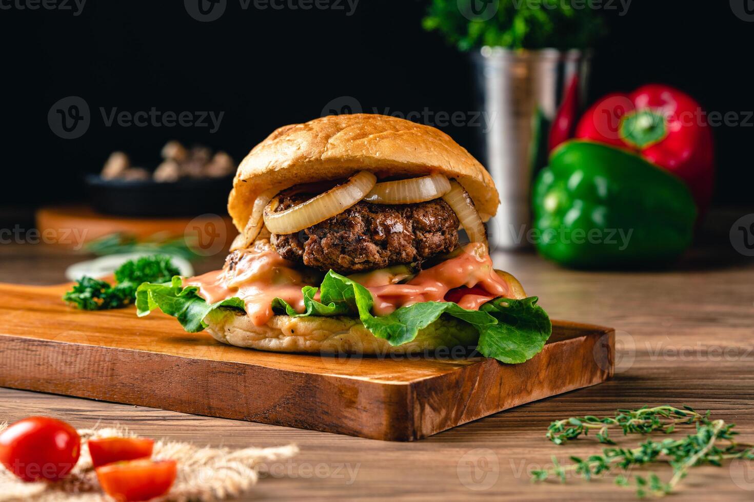 Fresh grilled homemade burgers with beef, tomato, fried egg, cheese and lettuce on rustic wooden background. fast food and junk food concept. photo