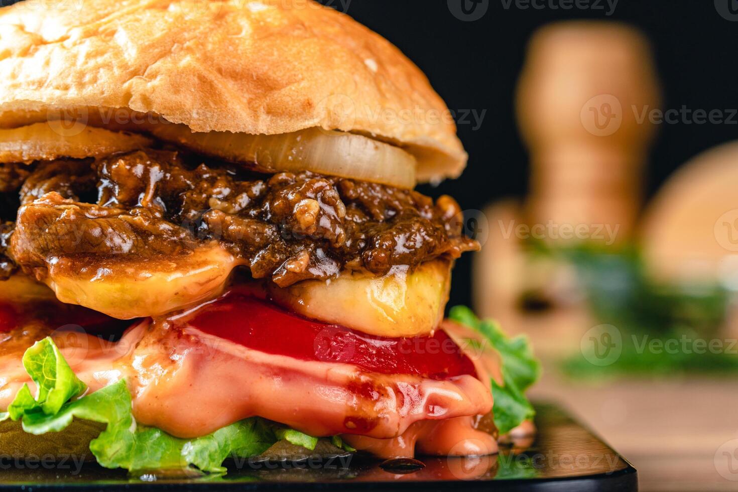 Fresh grilled homemade burgers with beef, tomato, fried egg, cheese and lettuce on rustic wooden background. fast food and junk food concept. photo