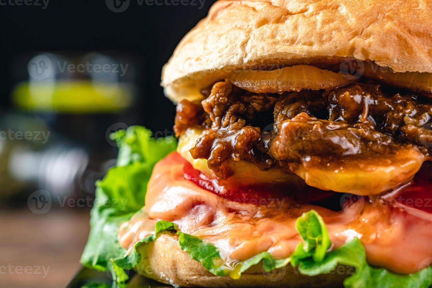 Fresh grilled homemade burgers with beef, tomato, fried egg, cheese and lettuce on rustic wooden background. fast food and junk food concept. photo
