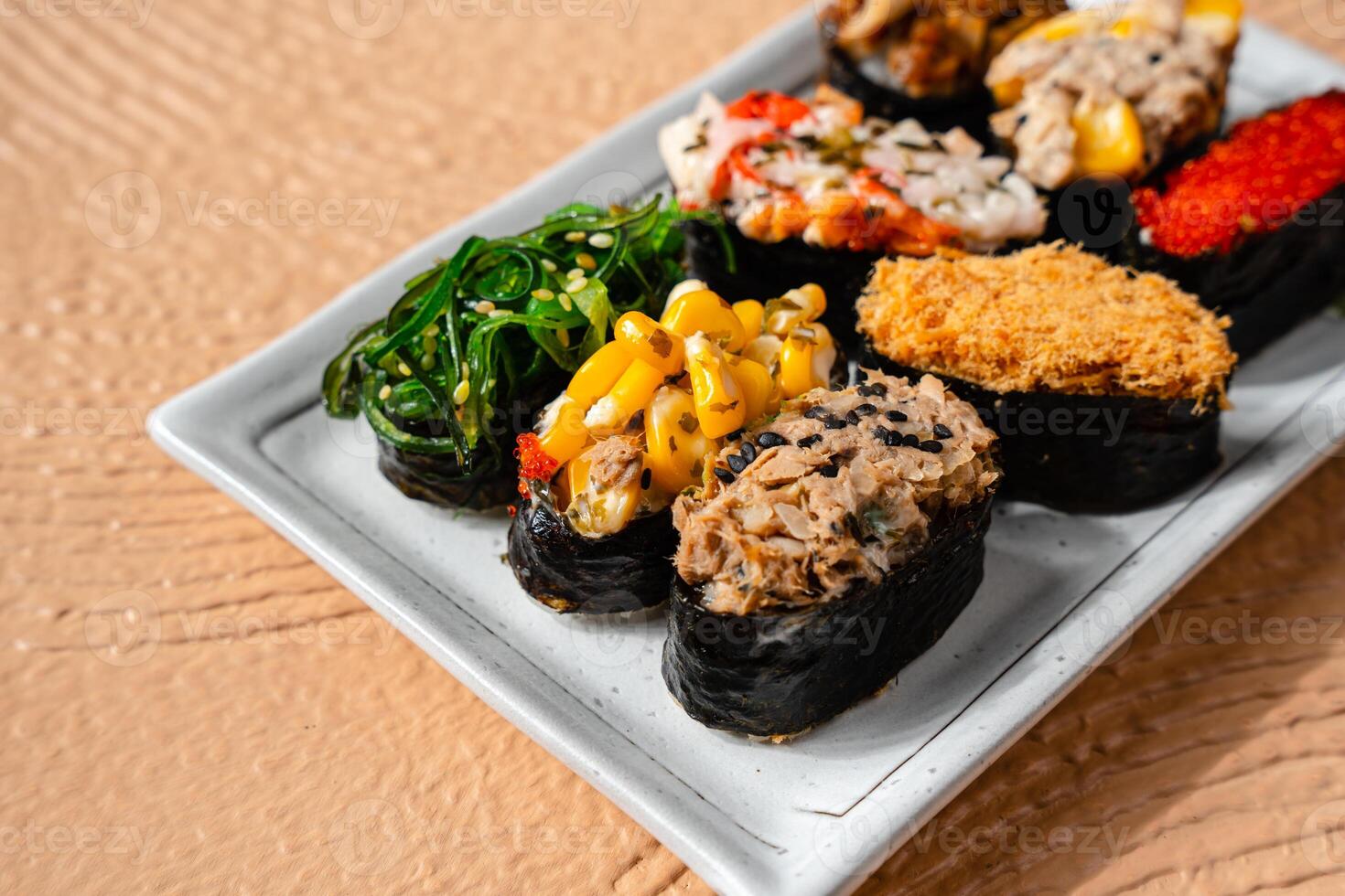 sushi is a Japanese dish of prepared vinegared rice, usually with some sugar and salt, accompanied by a variety of ingredients such as seafood, often raw and vegetables. photo