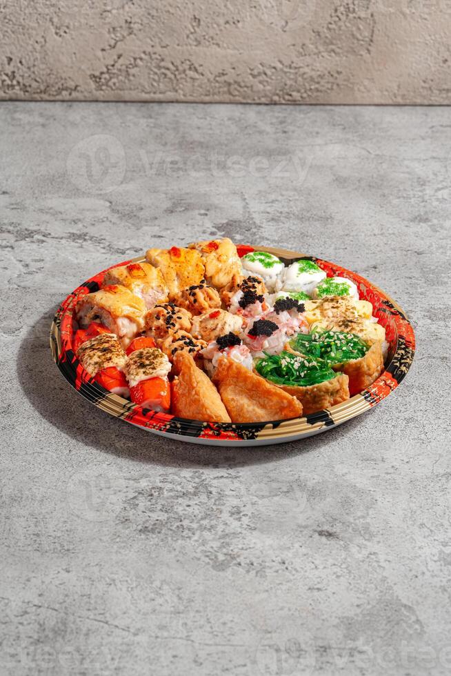 sushi is a Japanese dish of prepared vinegared rice, usually with some sugar and salt, accompanied by a variety of ingredients such as seafood, often raw and vegetables. photo