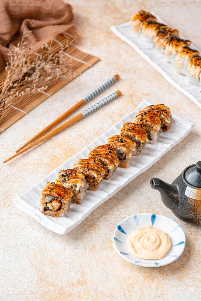 sushi is a Japanese dish of prepared vinegared rice, usually with some sugar and salt, accompanied by a variety of ingredients such as seafood, often raw and vegetables. photo