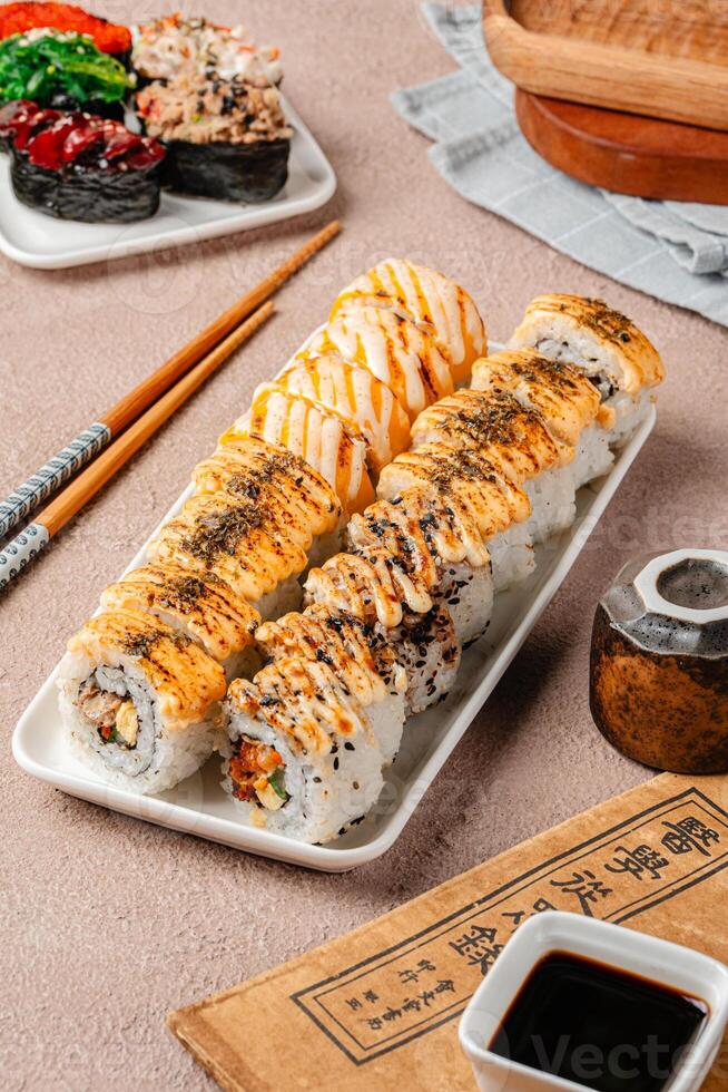 sushi is a Japanese dish of prepared vinegared rice, usually with some sugar and salt, accompanied by a variety of ingredients such as seafood, often raw and vegetables. photo