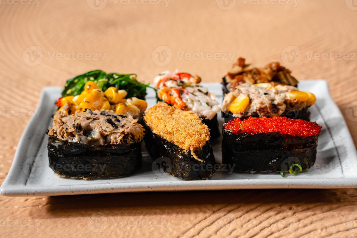 sushi is a Japanese dish of prepared vinegared rice, usually with some sugar and salt, accompanied by a variety of ingredients such as seafood, often raw and vegetables. photo