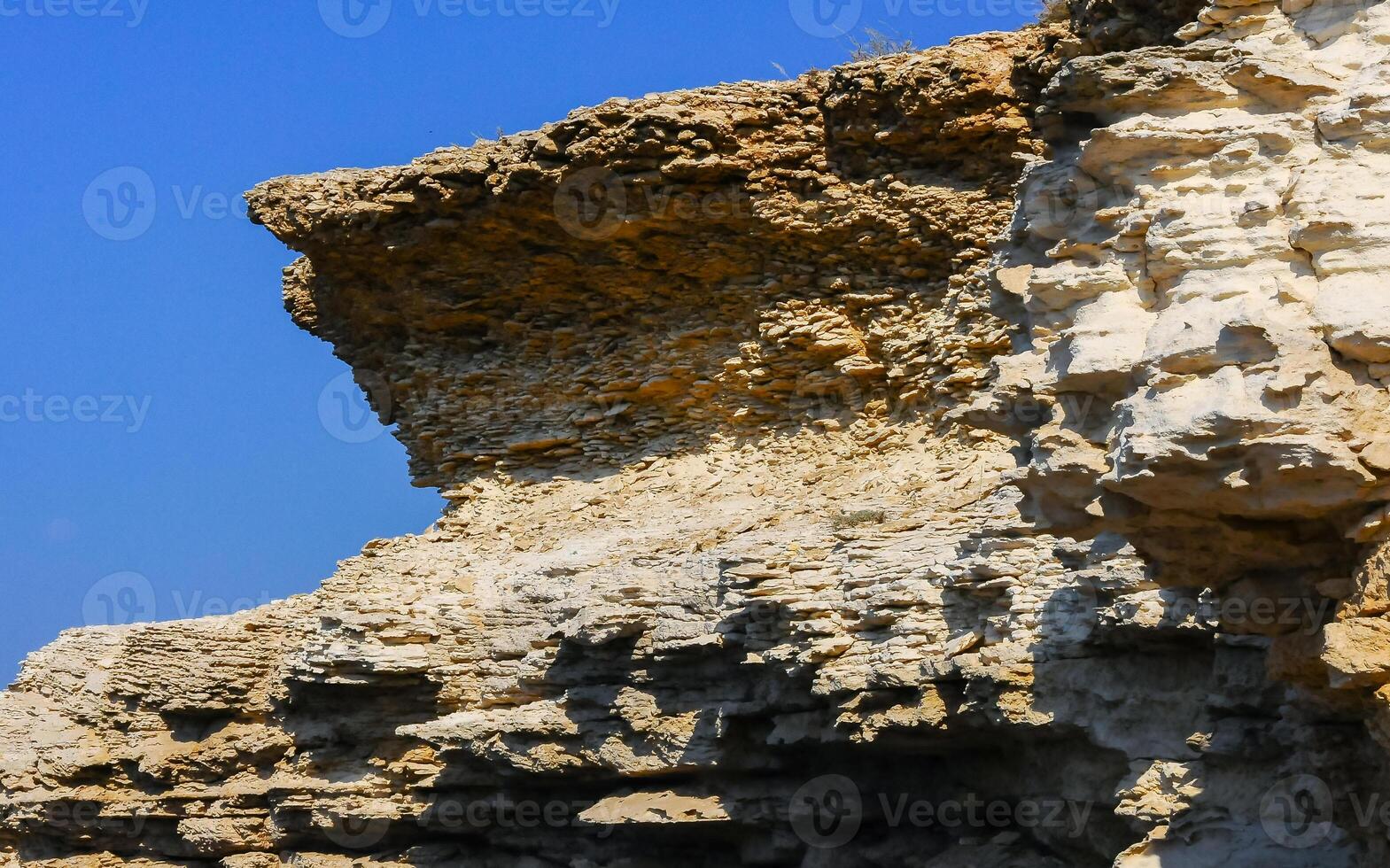 Layered erosion rocks of a steep coast in the western Crimea, Tarkhankut Peninsula photo