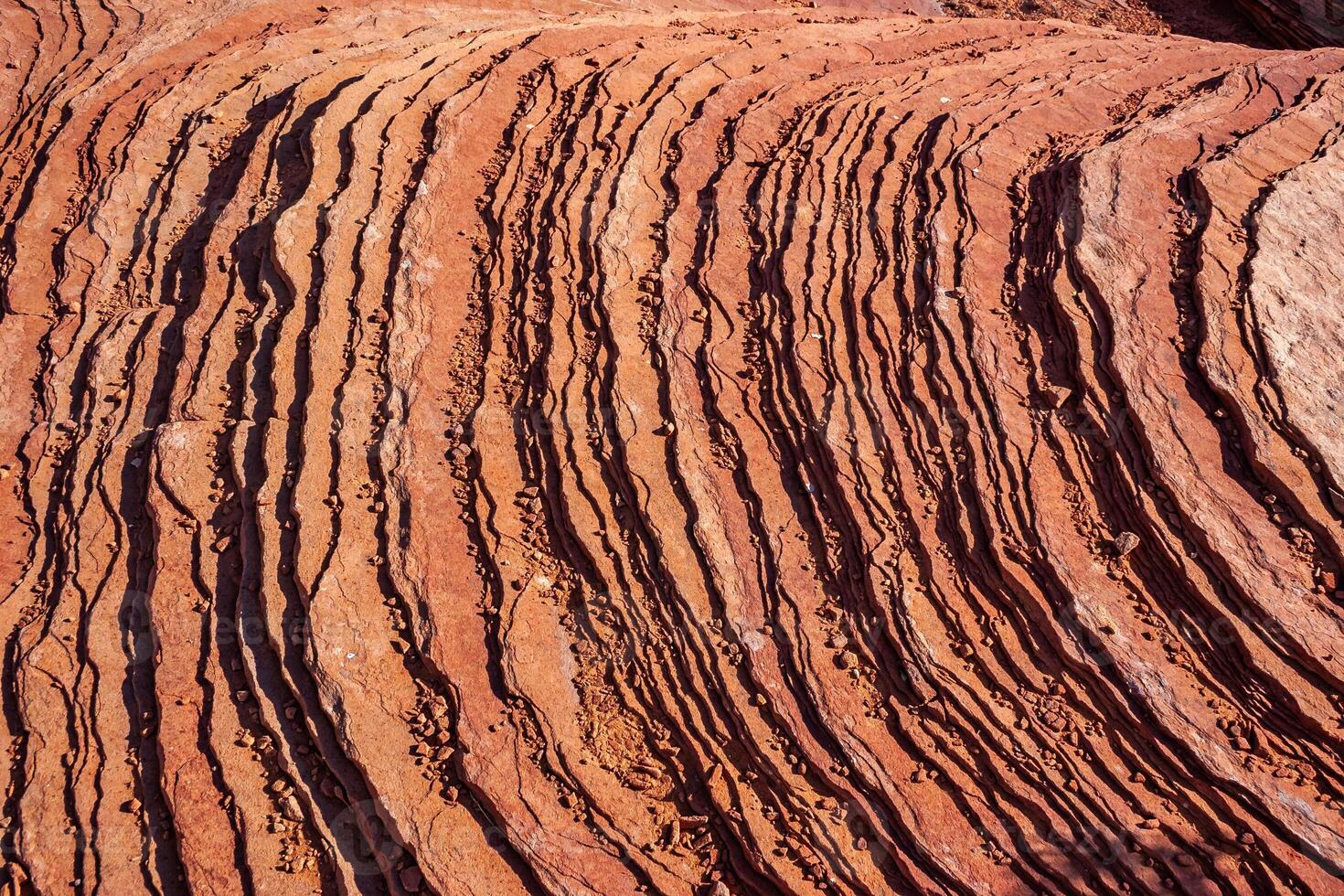Layered weathered red sandstone rock formations photo