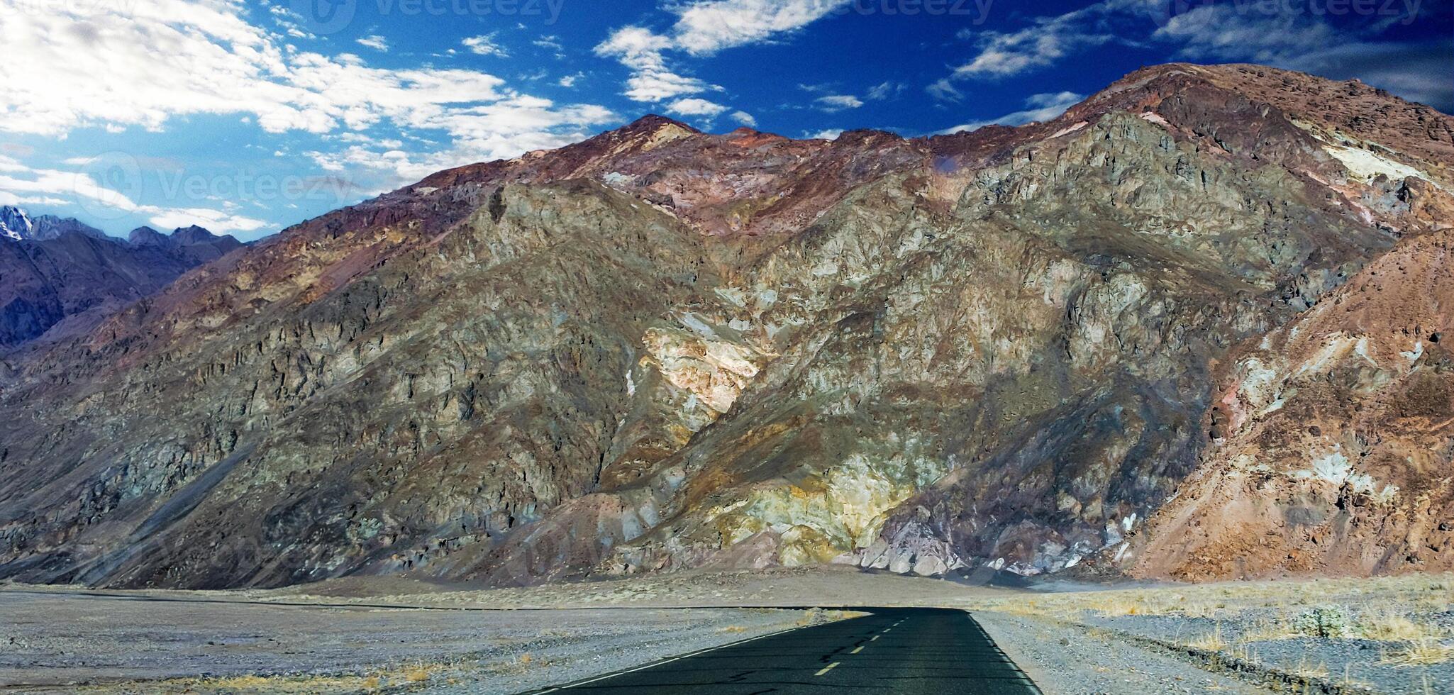 Road along Mountains with colorful rocks in Death Valley in the Arizona desert. photo