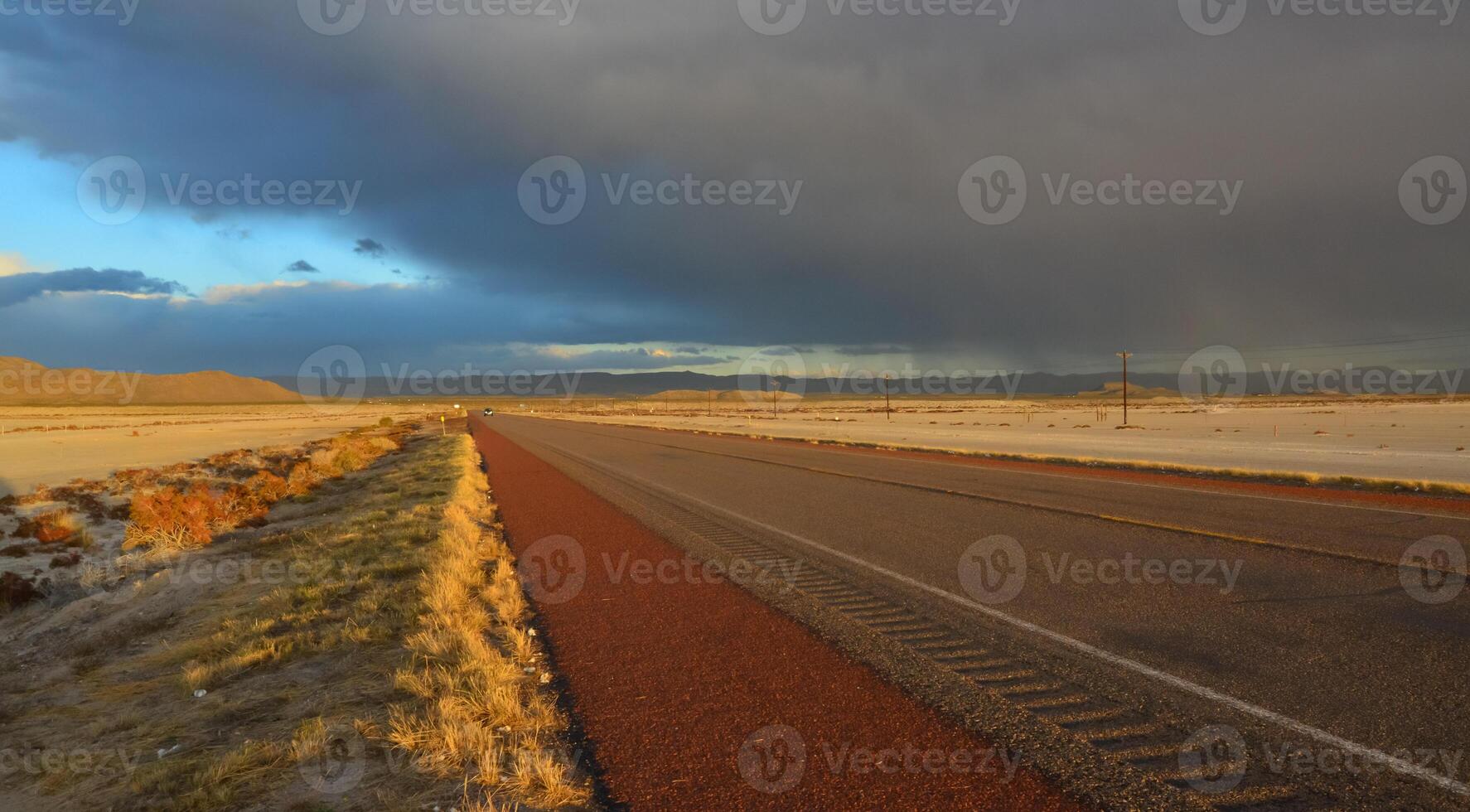 Roads during a red sunset and thunderclouds against the backdrop of the Guadalupe Mountains in New Mexico photo