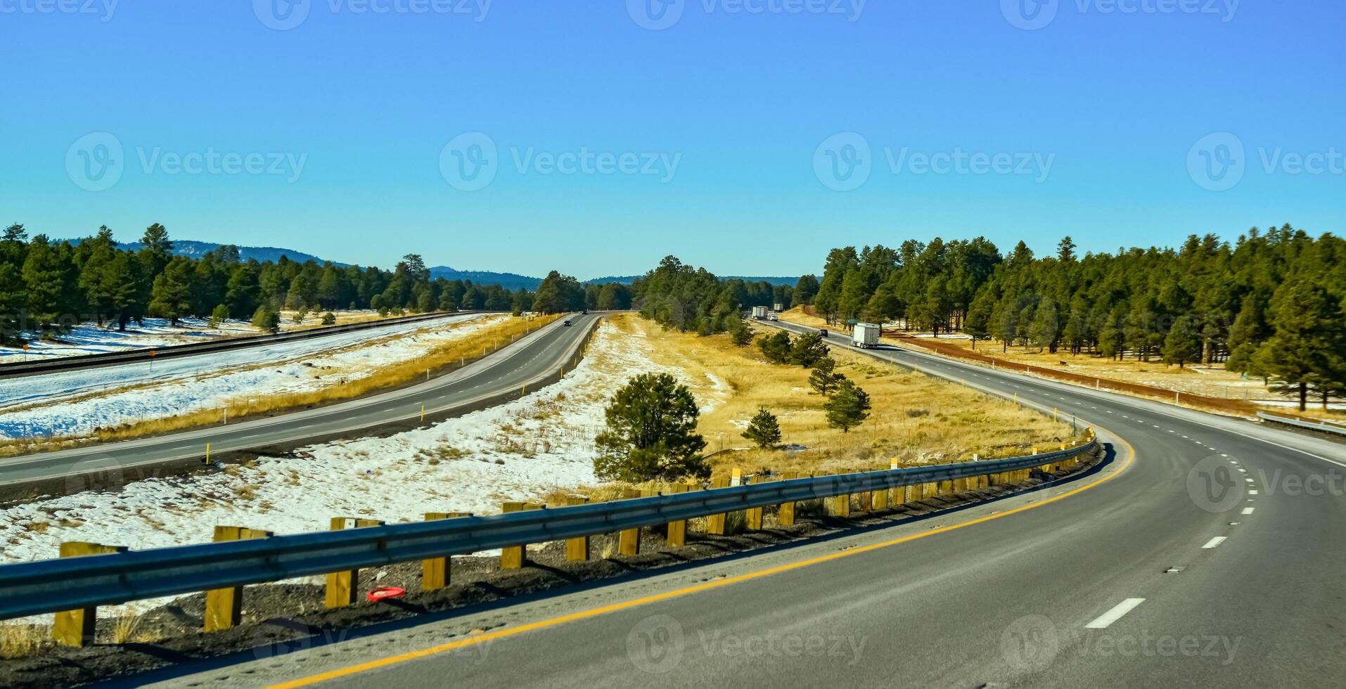 Highway in the foothills overgrown with coniferous forest in winter in Arizona photo
