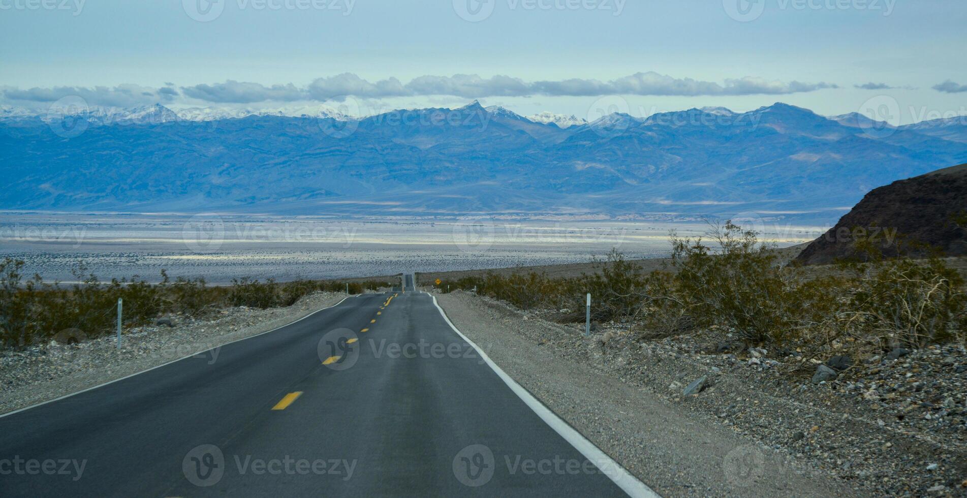 Straight Road in the California desert, going into the mountains near Death Valley National Park photo