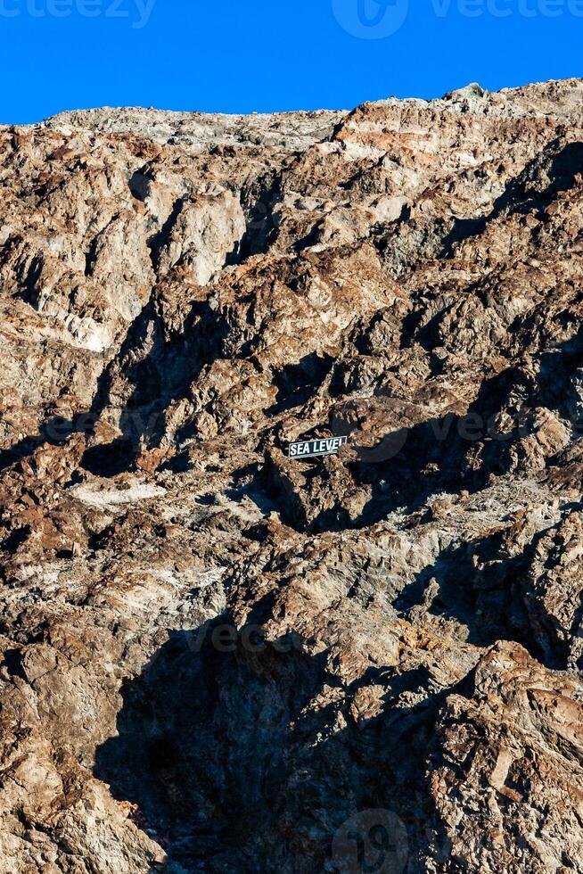 Sea level sign on a mountain in Death Valley National Park, California photo