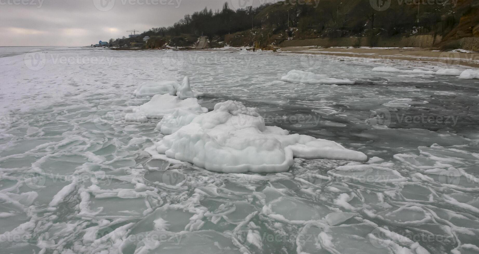 The Black Sea is frozen, ice floes float along the shore. Climate change, harsh winter photo