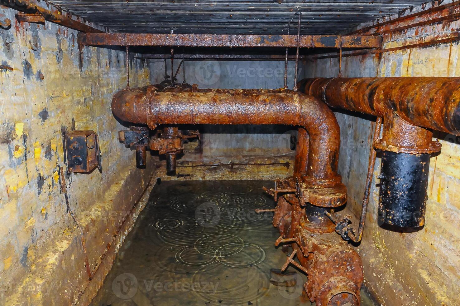 Rusty remains of communications of the Soviet bomb shelter in the Odessa catacombs, sawn out in the Pontic shell rock under the city photo